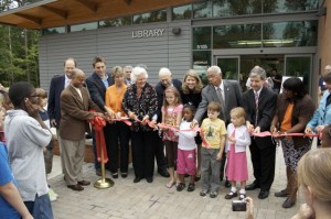 Community Children as well as those involved in the opening of the new library cut the ribbon.