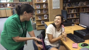 Amy Wedge laughs with Caroline Muma, now a Leesville alumni, after discussing a project. Muma was in Wedge’s upperclassman Speech I class last school year. (Photo courtesy of Erin Darnell)